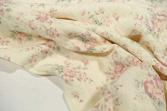 Muslin - flowers on a milky white background 140 g/m²