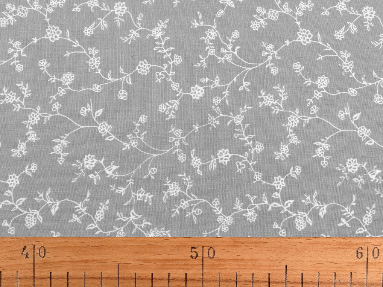 Image with 100% cotton fabric - white flowering stems on red 125 g/m² – available at Šarlotes Audumi