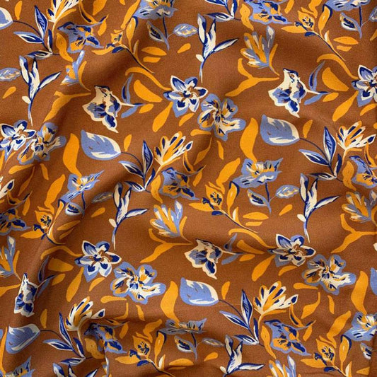 100% Viscose fabric - abstract floral pattern on an orange background 125 g/m²