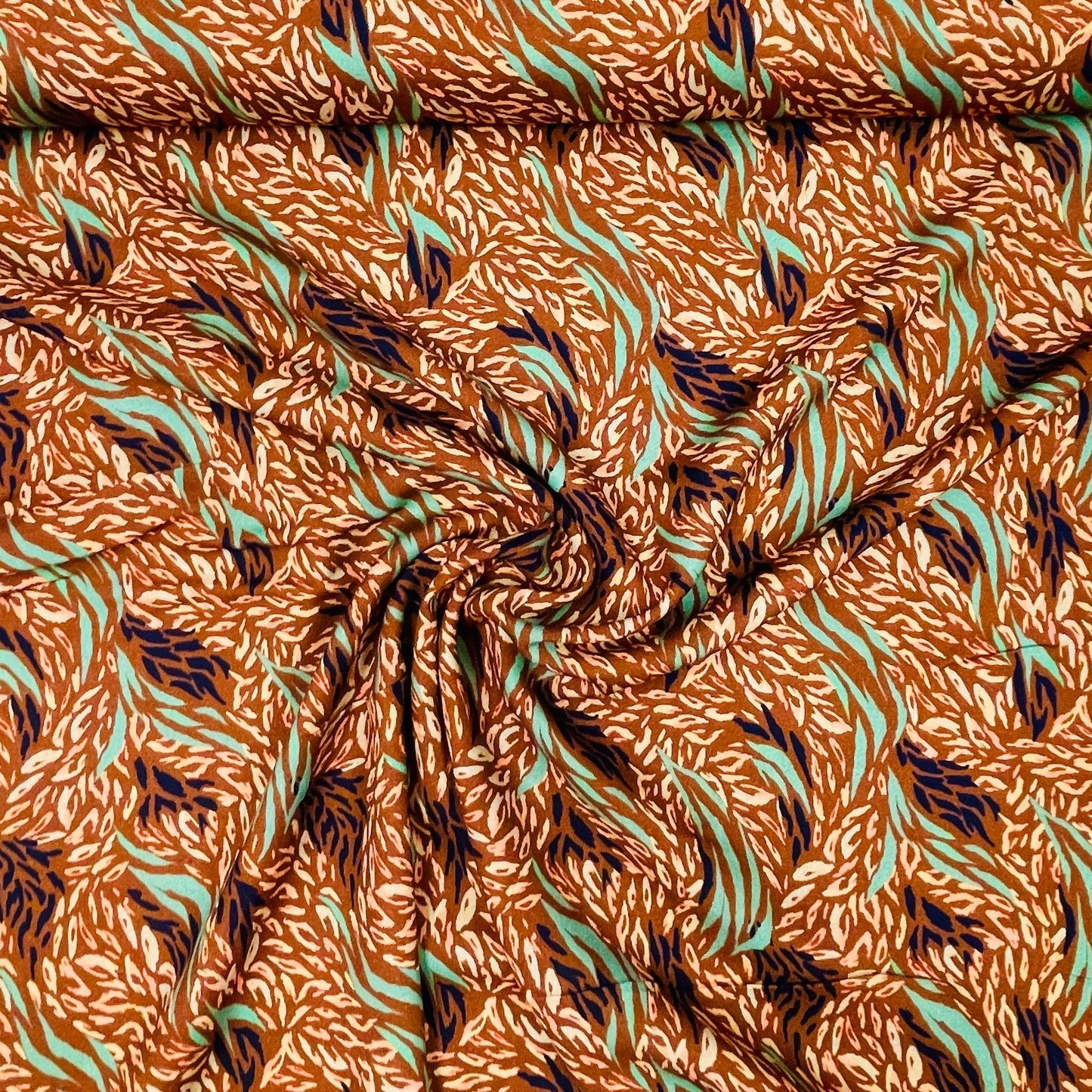 100% viscose fabric, brownish with a mint pattern 125 g/m²