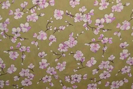 Image with 100% viscose fabric - cherry blossoms on a pistachio green background, 100 g/m² – available at Charlotte's Fabrics