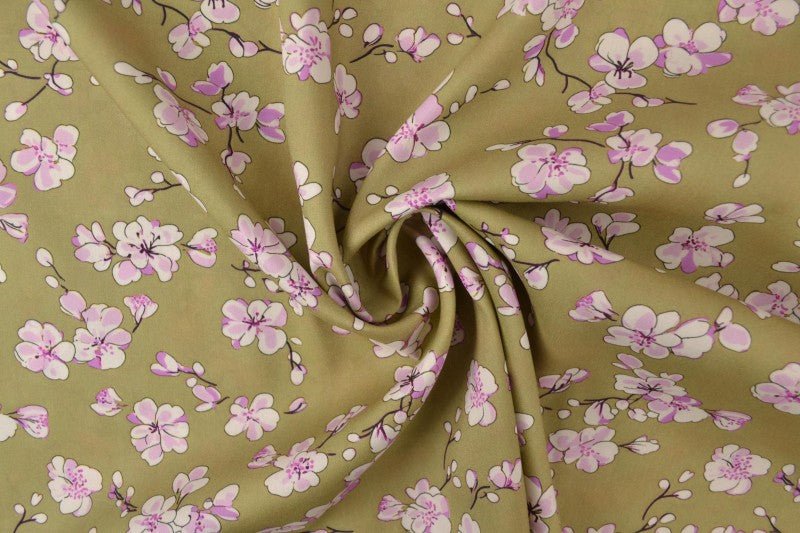 Image of 100% viscose fabric with cherry blossoms on a pistachio green background 100 g/m² – available at Šarlotes audumi