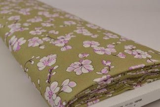 Image with 100% viscose fabric, cherry blossoms on a pistachio green background, 100 g/m² – available at Šarlotes audumi
