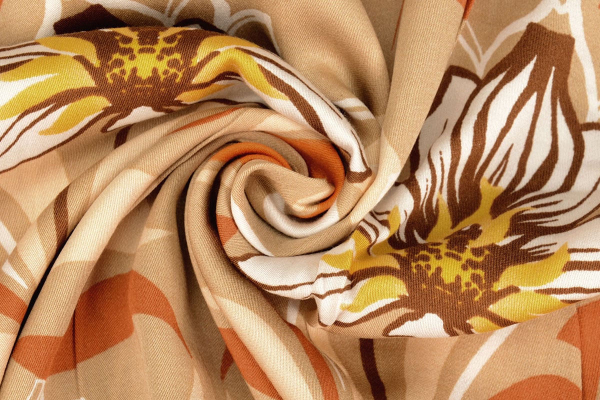 100% Viscose fabric - orange flowers 100 g/m²