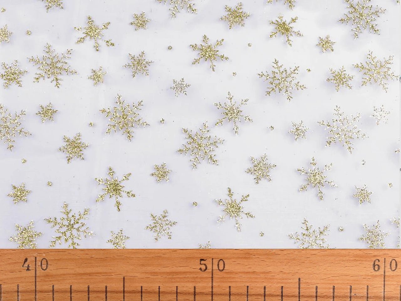 White organza with gold sparkling snowflakes – available online at Šarlotes audumi