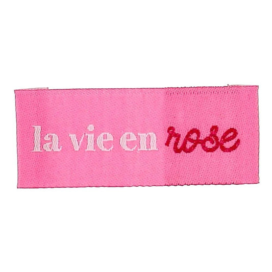 Zdjęcie wszywanych metek odzieżowych Bohin „La vie en rose” – patrz na życie przez różowe okulary, 2 × 5 cm, 4 szt. – dostępne online w Šarlotes audumi