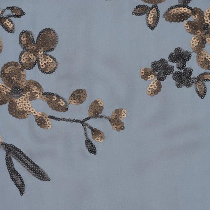 Image of stretchy satin fabric with floral embroidery and sequins in blue, black and gold – available online at Charlotte's Fabrics