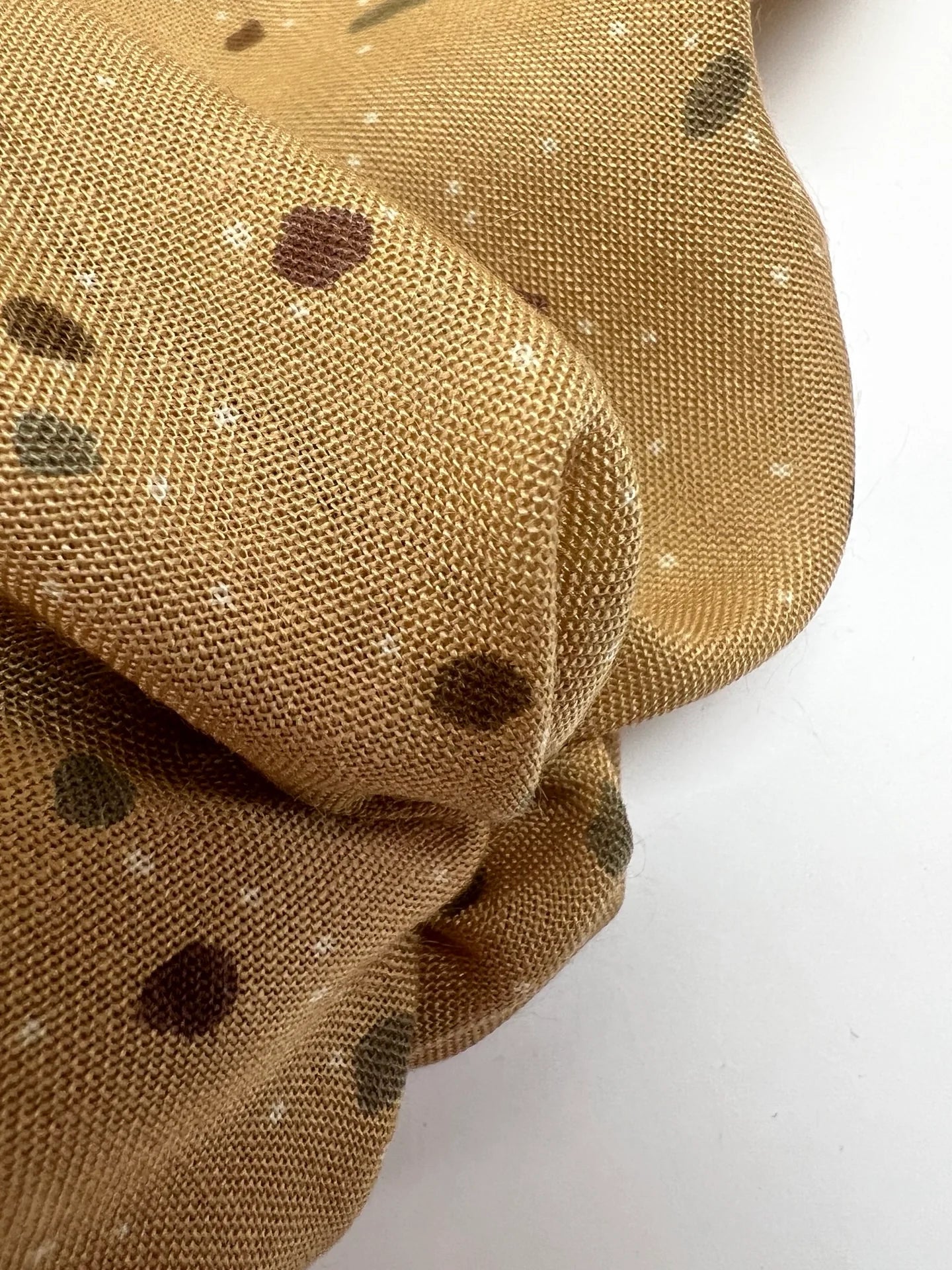 Image of Italian acrylic fabric with a beige and brown polka dot pattern – available online at Šarlotes audumi