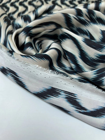 Image of Italian satin fabric in beige and blue with an abstract pattern, 85 g/m2 – available at Šarlotes audumi