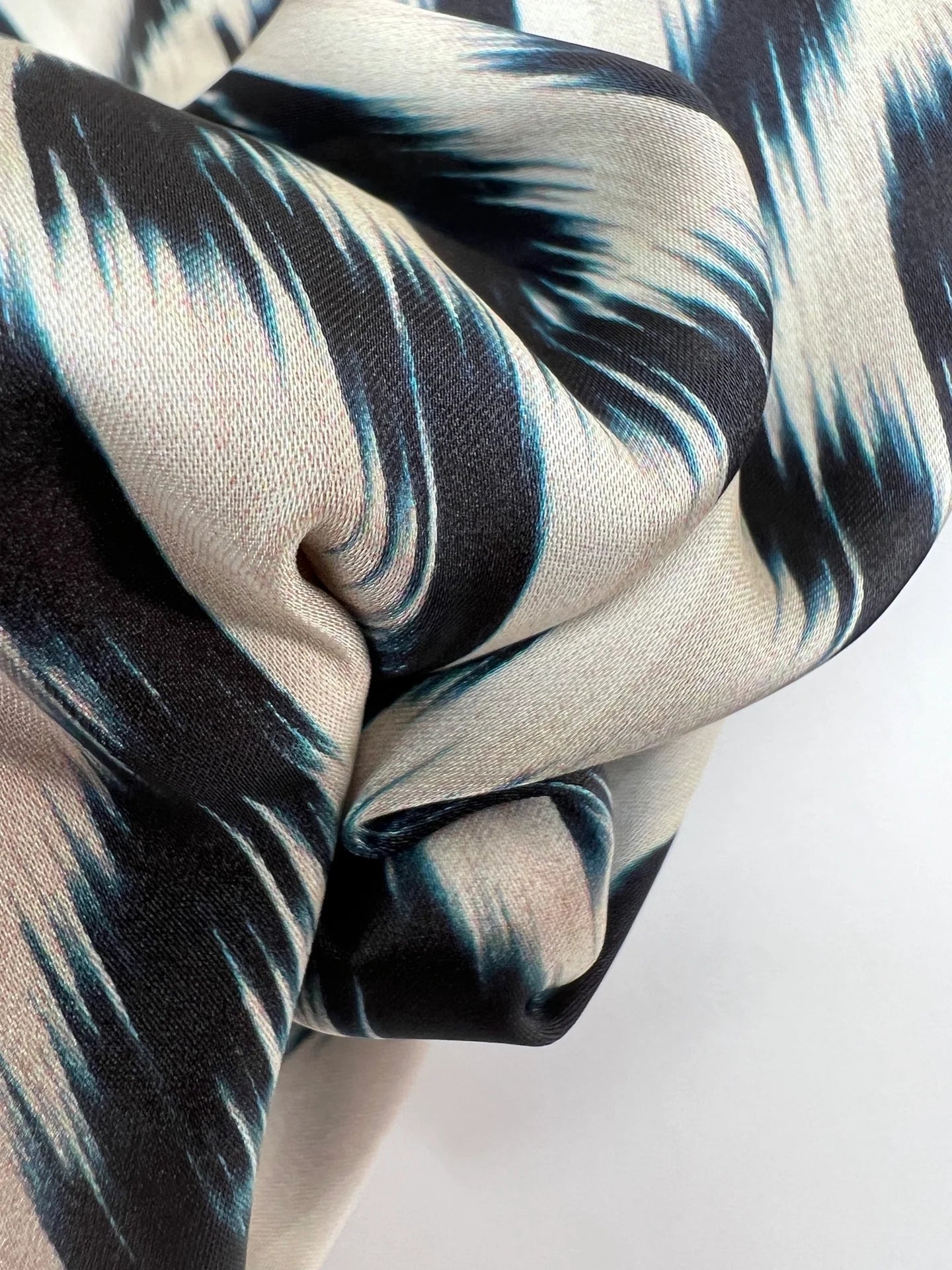 Image of Italian satin fabric in beige and blue with an abstract pattern 85 g/m2 – available at Šarlotes Audumi