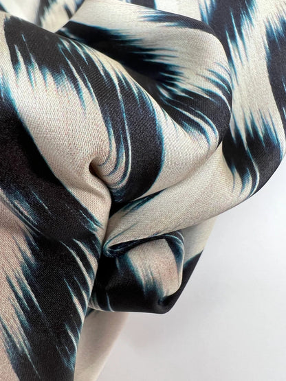 Image of Italian satin fabric in beige and blue with an abstract pattern 85 g/m2 – available at Šarlotes Audumi