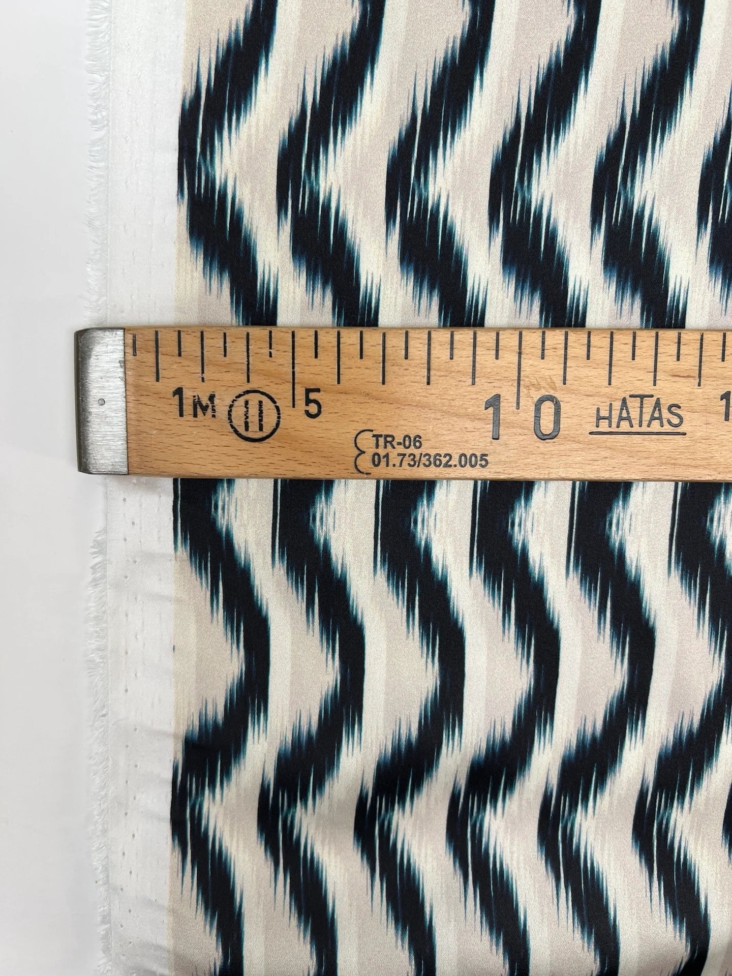 Image of Italian satin fabric in beige and blue with an abstract pattern 85 g/m2 – available at Šarlotes audumi