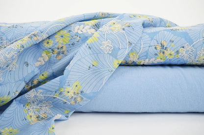 Image of embroidered cotton fabric - yellow flowers on blue 115 g/m² – available at Charlotte Fabrics