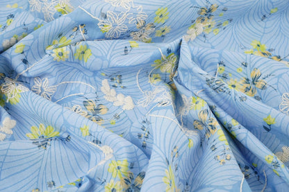 Image of embroidered cotton fabric - yellow flowers on blue 115 g/m² – available at Šarlotes audumi