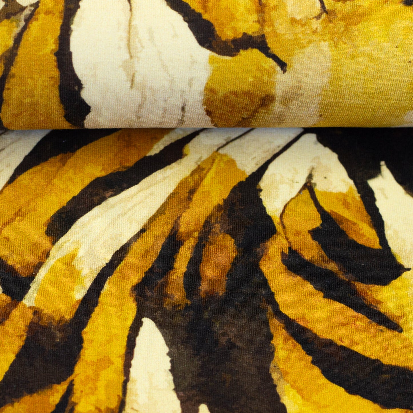 Image with cotton loopback knit - honey yellow abstract pattern 260 g/m² – available at Šarlotes audumi