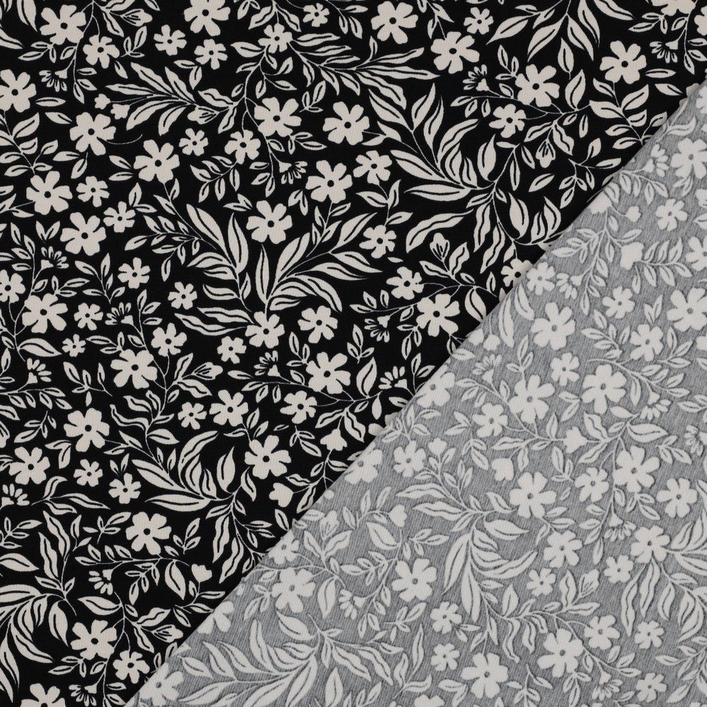 Image of Cotton jersey - white flowers on black 200 g/m² – available at Šarlotes audumi