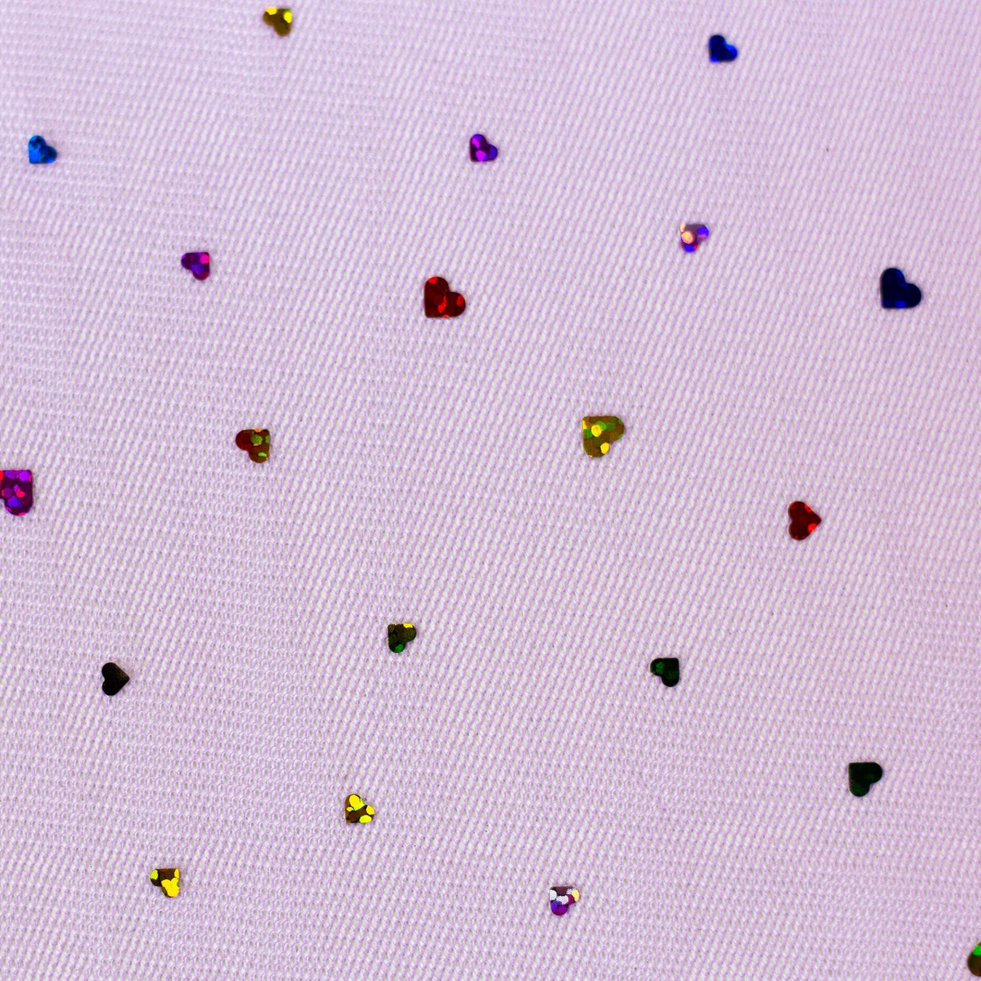 Image of soft tulle with hearts on a lilac background 40 g/m² – available at Šarlotes audumi