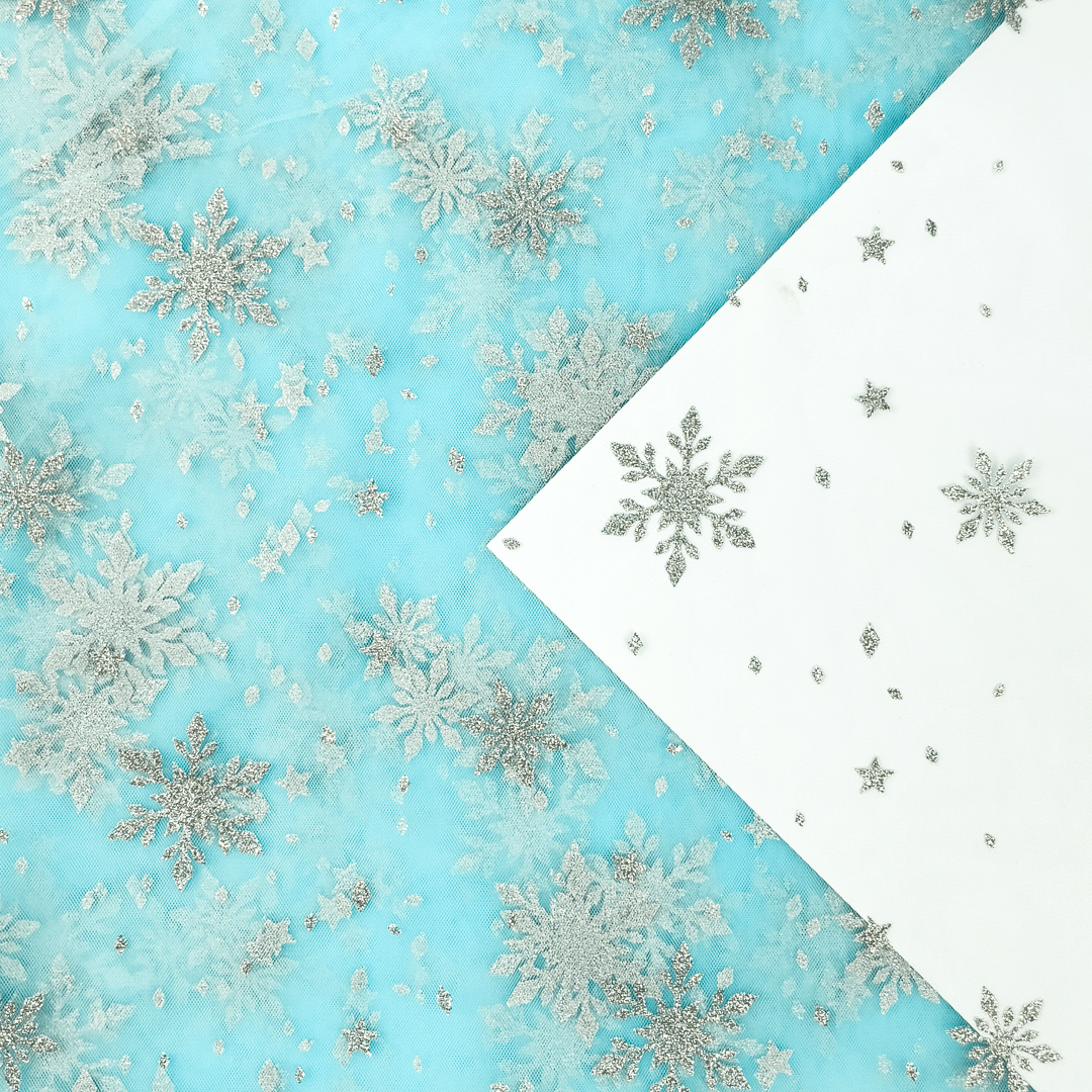 Image of soft tulle with silver snowflakes - aqua shade 30 g/m² – available at Charlotte's Fabrics