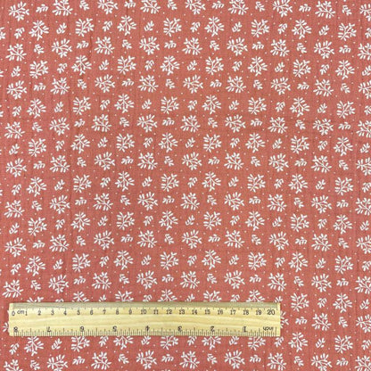 muslin - white flowers on an orange background 130 g/m²
