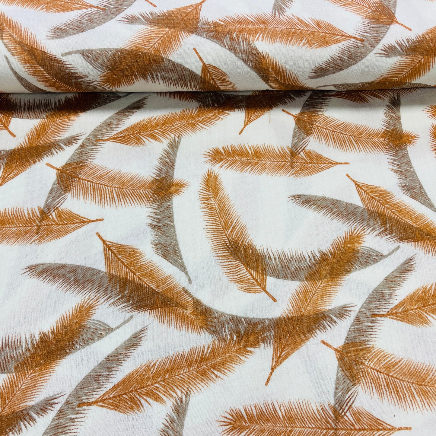 Image with Muslin - orange and gray feathers 140 g/m² – available at Charlotte's Fabrics