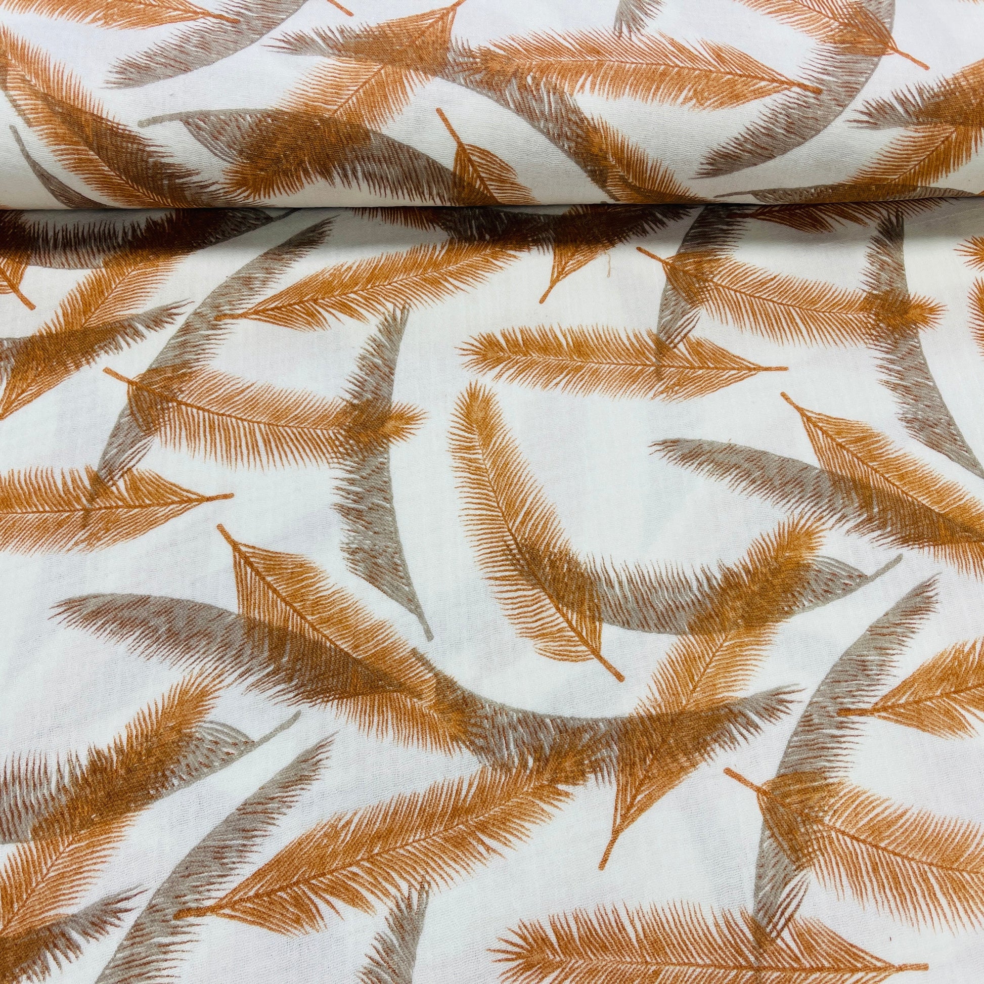 Image with Muslin - orange and gray feathers 140 g/m² – available at Charlotte's Fabrics