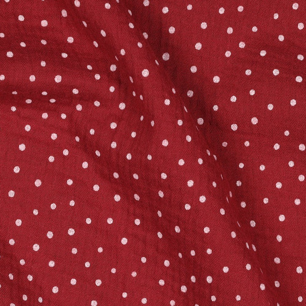 Image of muslin with dots on a dark red background, 125 g/m² – available at Charlotte Fabrics