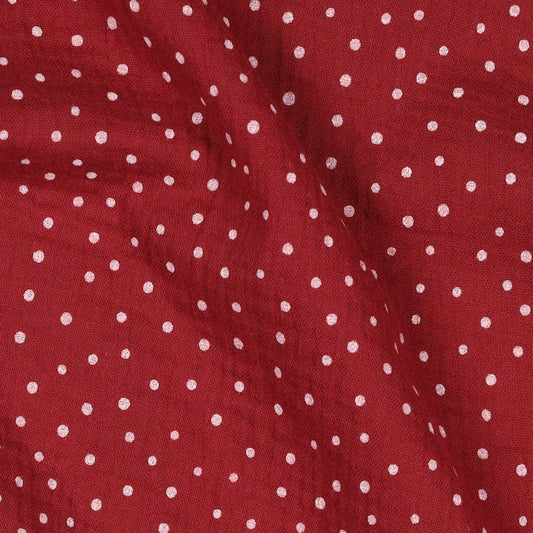 Image of muslin with dots on a dark red background, 125 g/m² – available at Charlotte Fabrics