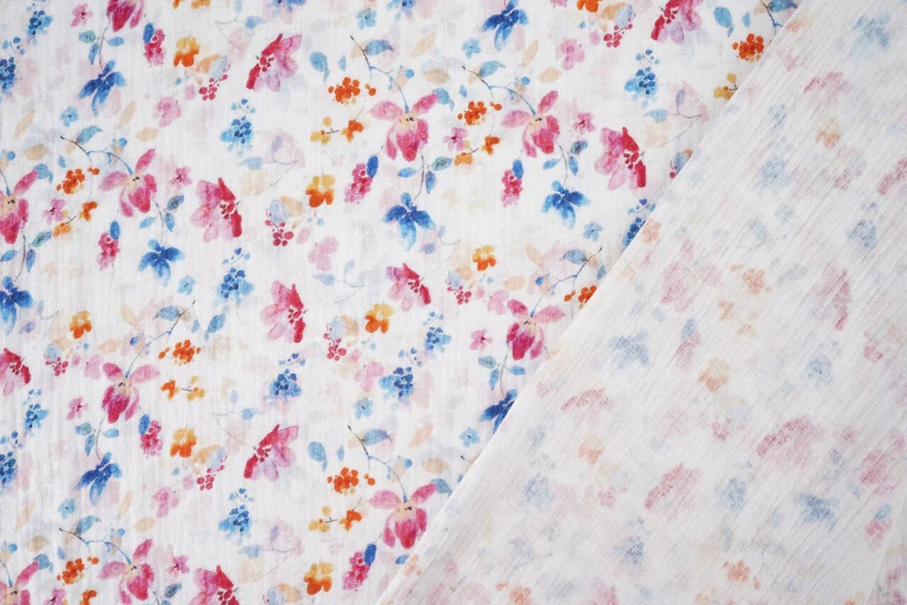Image of muslin with blue and pink flowers – available online at Charlotte Fabrics