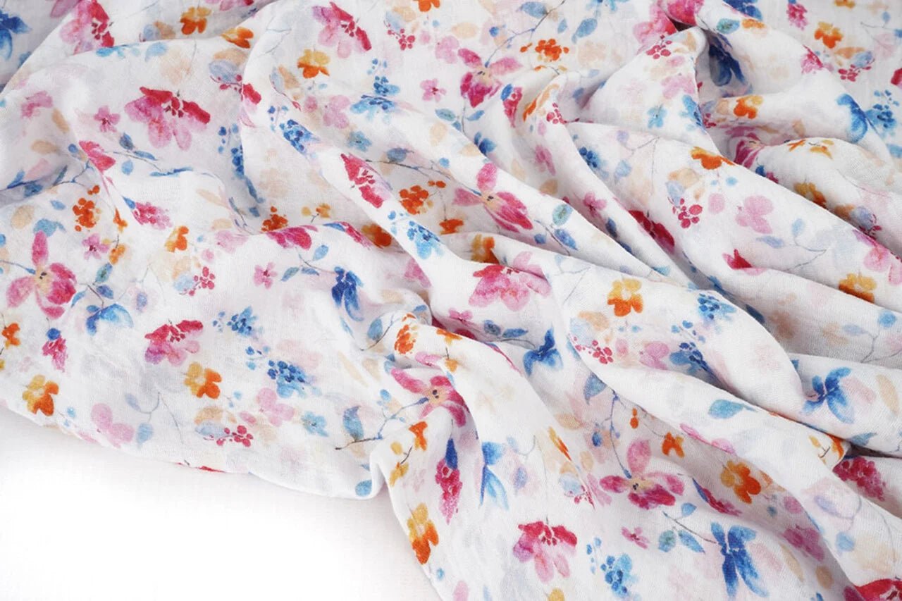 Image of blue and pink flowers on muslin – available online at Charlotte's Fabrics