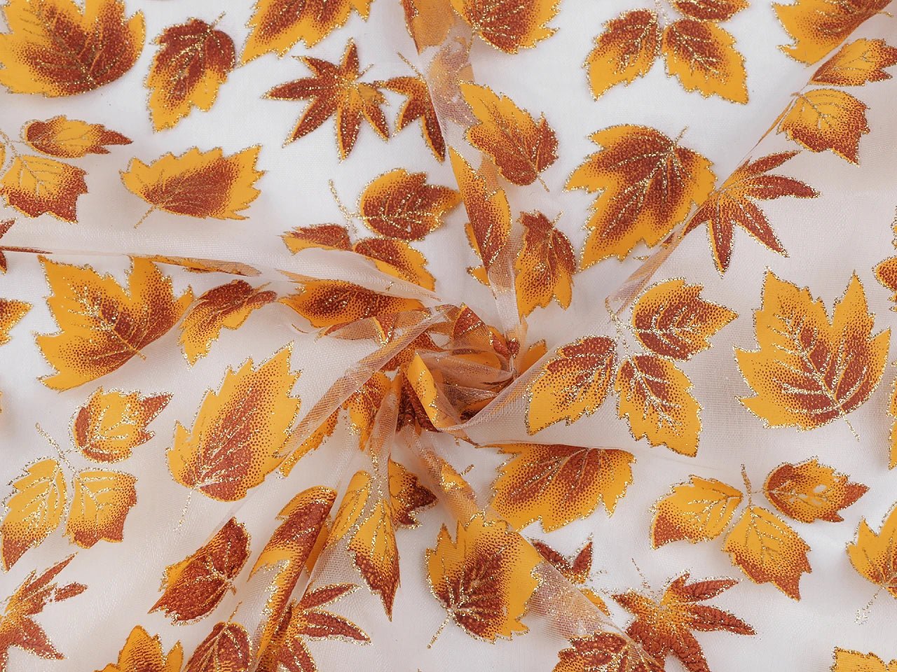 Image of organza fabric with a shimmering autumn leaf pattern, available online at Šarlotes audumi