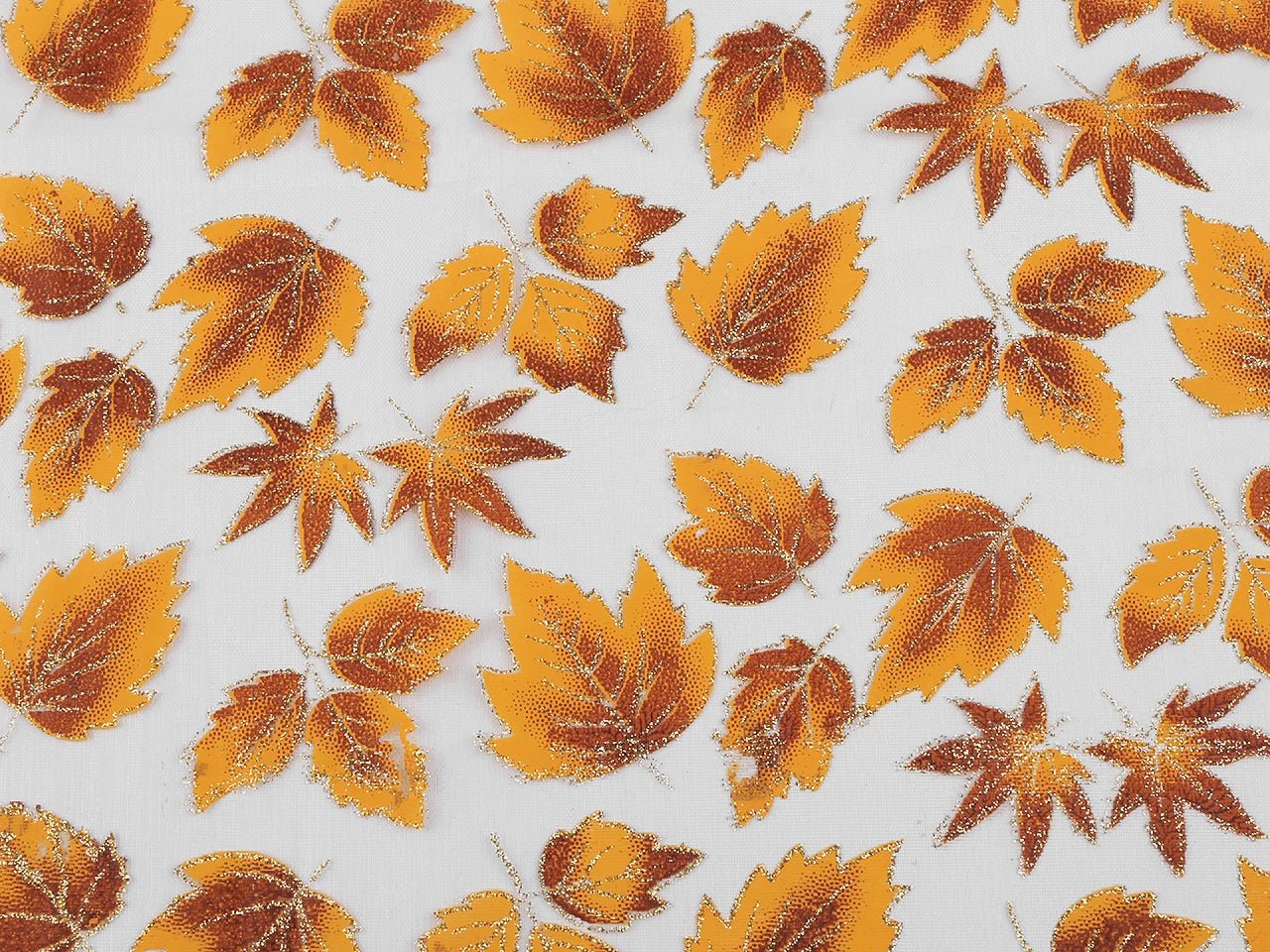 Organza fabric with a shimmering autumn leaf pattern – available online at Charlotte's Fabrics