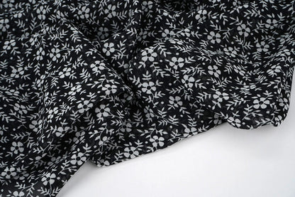 Chiffon - white flowers on a black background | 150 cm | 65 g/m²