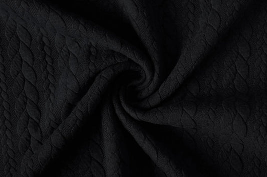 Image of knitted fabric with a knit pattern - black braids 340 g/m² – available at Šarlotes audumi