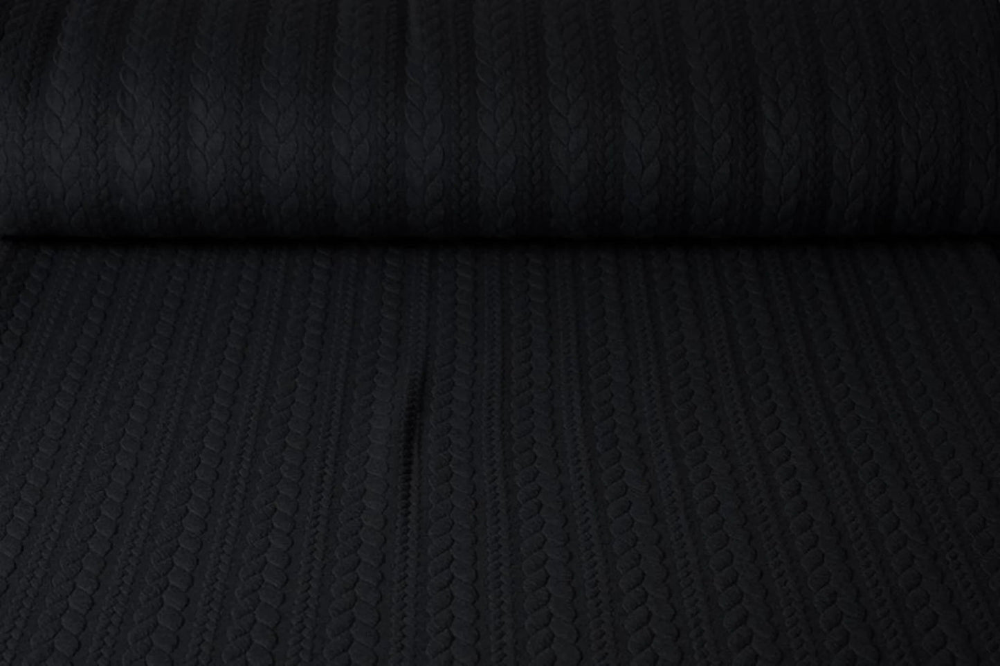 Image of knitted fabric with a knit pattern - black braids 340 g/m² – available at Šarlotes audumi