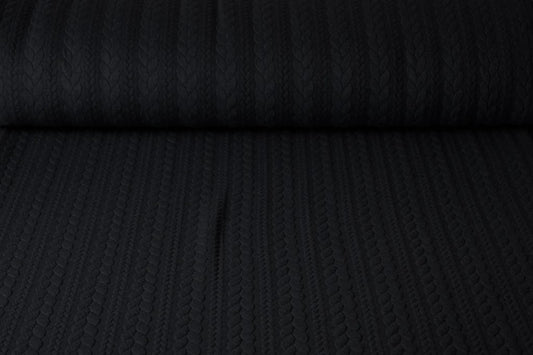 Image of knitted fabric with a knit pattern - black braids 340 g/m² – available at Šarlotes audumi