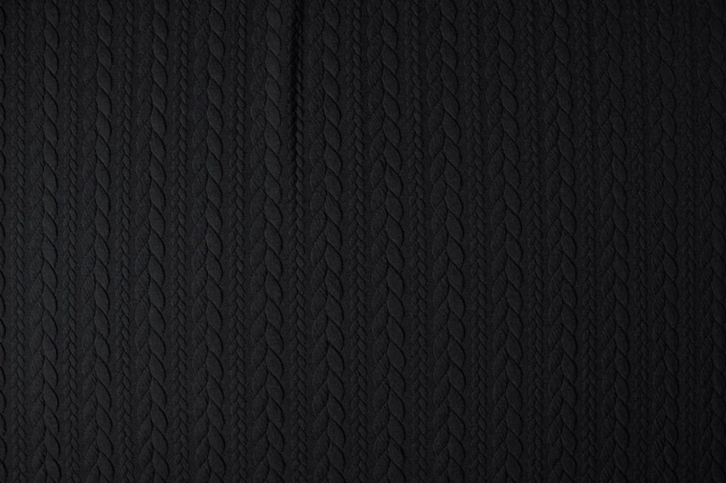 Image of knit fabric with a knitted pattern - black braids 340 g/m² – available at Šarlotes audumi