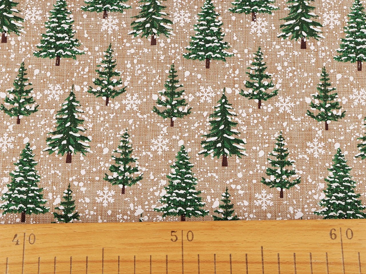 Image of Christmas decorative fabric with fir trees and snow – available online at Šarlote Fabrics