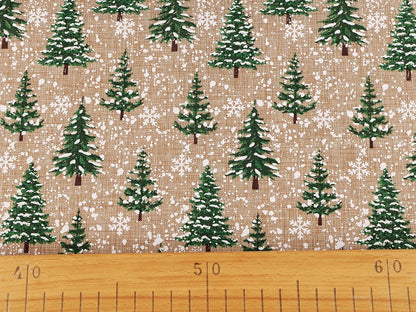 Image of Christmas decorative fabric with fir trees and snow – available online at Šarlote Fabrics