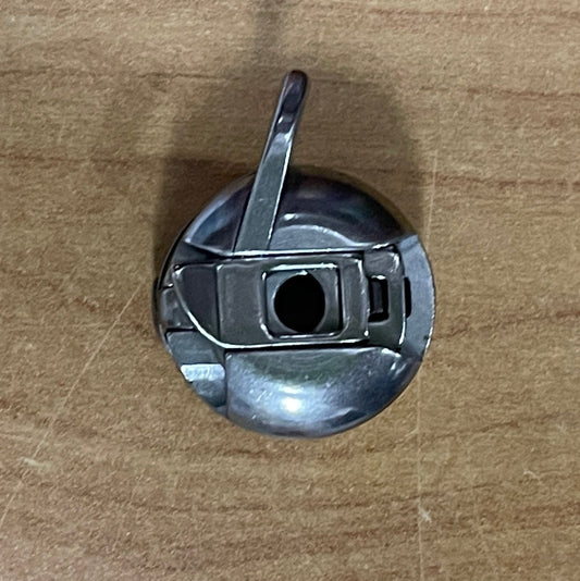 Metal bobbin for sewing machines