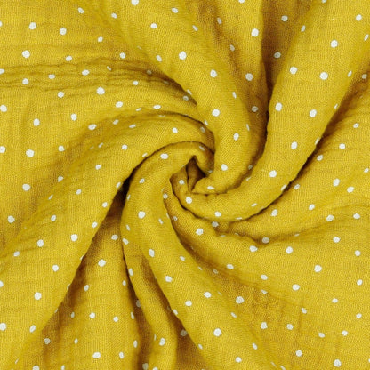 Mousseline dots on a honey-yellow background 130 g/m²