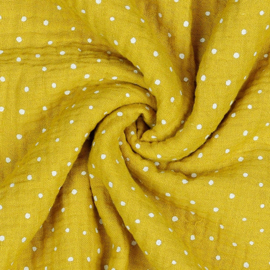 Mousseline dots on a honey-yellow background 130 g/m²