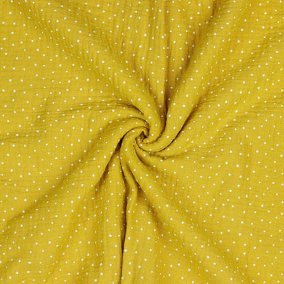 Muslin dots on a honey-yellow background 130 g/m²